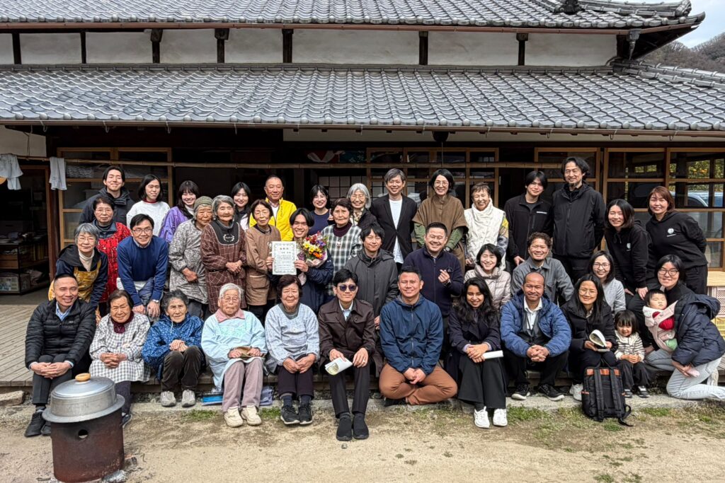 Group photo with island residents at community lunch